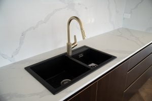 Black stone sinc with gold tap